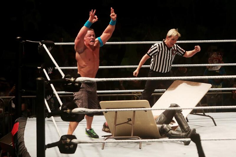 John Cena celebrates his defeat of Seth Rollins in their street fight in Abu Dhabi. Christopher Pike / The National







