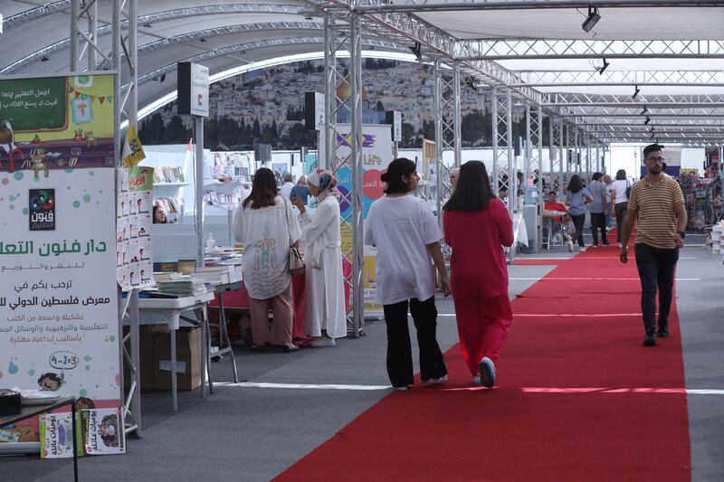 People on the red carpet at the Palestine International Book Fair.