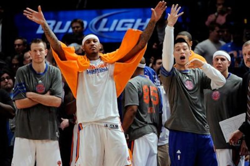 epa03163328 The Knicks' Carmelo Anthony (C) and Jeremy Lin (R) right yell to their teammates late in the second half of the game between the Orlando Magic and the New York Knicks at Madison Square Garden in New York, New York, USA, 28 March 2012.  EPA/JUSTIN LANE Corbis Out