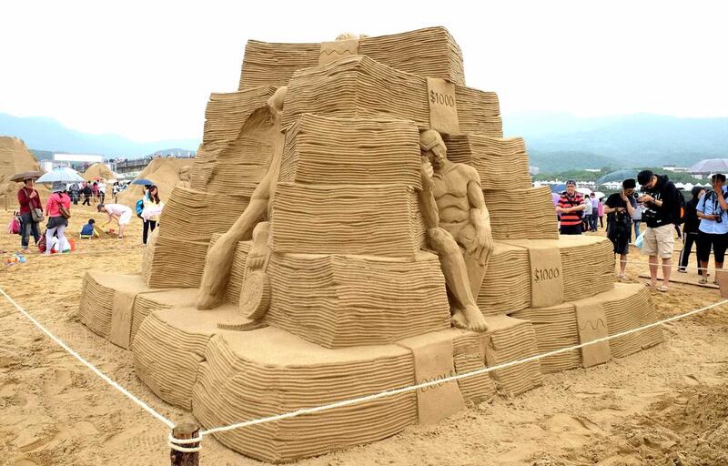 This sand sculpture Not True Wealth is by Irish artist Daniel Doyle. AFP
