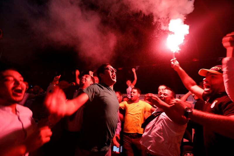 Supporters of Tunisia's Ennahda party celebrate, after the party gained most votes in Sunday's parliamentary election, according to an exit poll by Sigma Conseil. Reuters