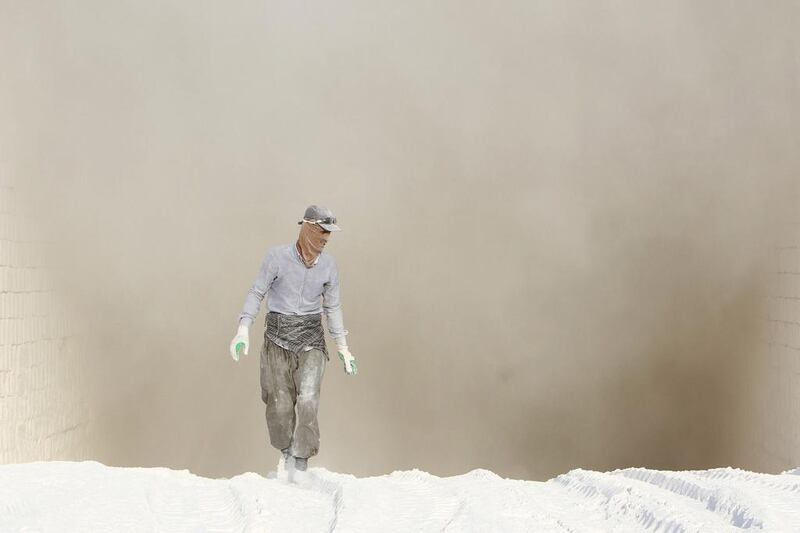 A worker covered in dust at a gypsum factory in the Makhmur district, Iraq. Azad Lashkari / Reuters