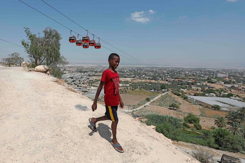 A Palestinian youth walks down a hillside overlooking the West Bank city of Jericho. When Israeli Prime Minister Benjamin Netanyahu unveiled a map of his plans in September, he pointed to a long blue zone to be annexed, leaving a brown speck in the middle: Jericho. Now the city's farmers in the occupied West Bank fear being marooned on a scrap of Palestinian land if Israel forges ahead with its plans to annex the Jordan Valley.  AFP