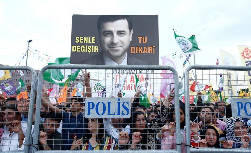 A supporter of Turkey's main pro-Kurdish Peoples' Democratic Party (HDP) holds a portrait of their jailed former leader and presidential candidate Selahattin Demirtas during a campaign event in Istanbul, Turkey, June 17, 2018. REUTERS/Huseyin Aldemir