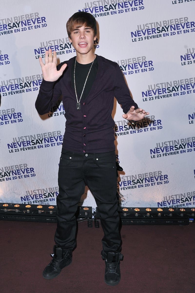 Wearing an aubergine cardigan, the singer attends the 'Justin Bieber: Never Say Never' premiere on February 17, 2011, in Paris. Getty Images for Paramount