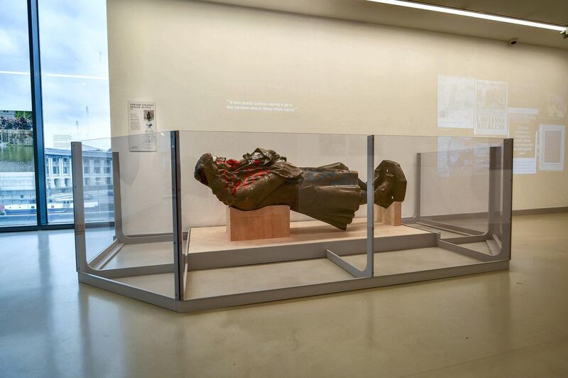 A view of the statue of slave trader Edward Colston, which was toppled during a protest on June 7, 2020 on display at the M Shed as part of the preview of 'The Colston statue: What next?', in Bristol, England, Thursday June 3, 2021. A statue of a 17th-century slave trader that was toppled during anti-racism protests in the English city of Bristol is being displayed in a museum, with visitors being asked to help decide its fate. The bronze likeness of Edward Colston was pulled from its pedestal and dumped in Bristol harbor a year ago, sparking a nationwide debate about commemoration and Britain‚Äôs slave-trading history. City workers hauled the statue out of the water and have kept it in storage ever since. (Ben Birchall/PA via AP)