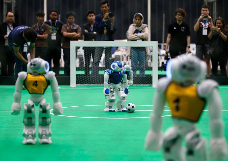 Robots from team Australia (yellow) and Iran (blue) play football after the opening ceremony of the RoboCup Asia-Pacific 2017 in Bangkok, Thailand. More than 1,000 students from 25 countries with more than 130 team will participate in the four-day contest of the region's first robot competition, the RoboCup Asia-Pacific 2017. The event is held to encourage global robotics research and development. Narong Sangnak / EPA