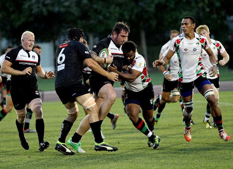 Dubai Exiles, in black, won the UAE Premiership title after a comprehensive victory over outgoing champions Abu Dhabi Harlequins. Satish Kumar / The National