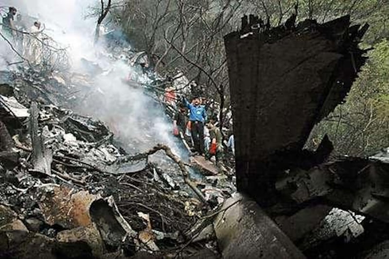 Rescue workers search the crash site. By last night, 115 bodies had been recovered, most of which were unidentifiable.