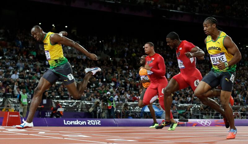Jamaica's Usain Bolt, left, crosses the finish line ahead of Jamaica's Yohan Blake, right, United States' Justin Gatlin, second from right, United State's Ryan Bailey, third from right, and Netherlands' Churandy Martina to win gold in the men's 100-meter final during the athletics in the Olympic Stadium at the 2012 Summer Olympics, London, Sunday, Aug. 5, 2012. (AP Photo/David J. Phillip )