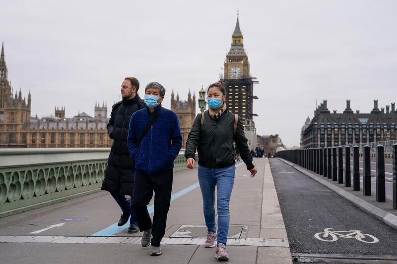 People cross a quiet Westminster Bridge in London. The UK  recorded the highest number of confirmed new Covid-19 infections on Wednesday since the pandemic began. AP Photo