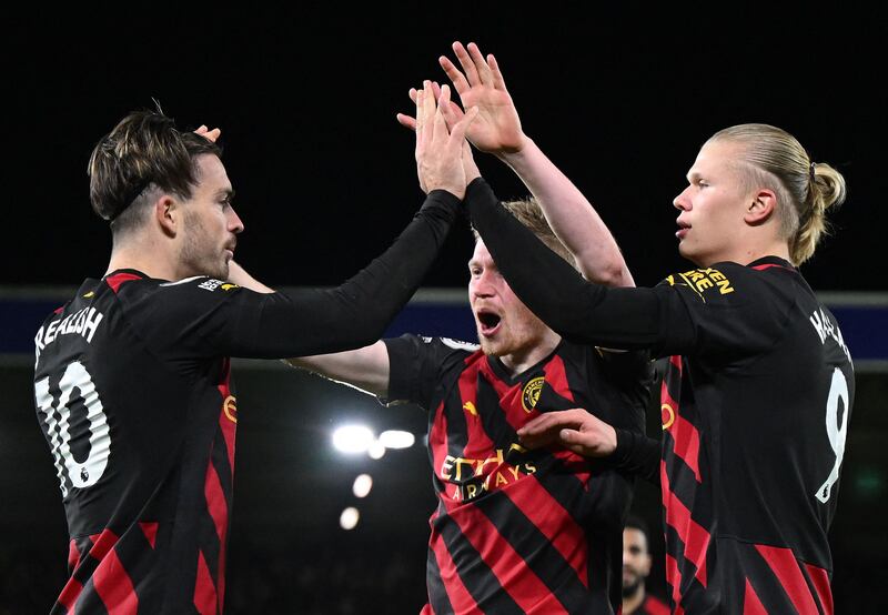 Erling Haaland celebrates scoring City's second goal with Kevin De Bruyne and Jack Grealish. AFP
