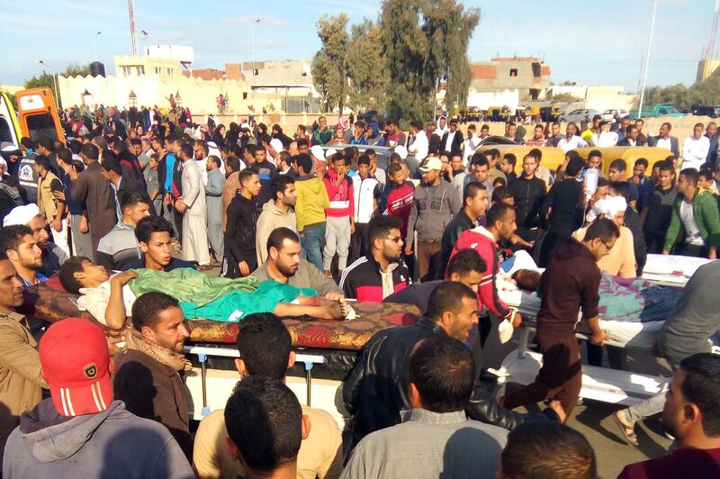 Egyptians carry victims on stretchers following a gun and bombing attack on the Rawda mosque near the North Sinai provincial capital of El-Arish on November 24, 2017.
Armed attackers killed at least 235 worshippers in a bomb and gun assault on the packed mosque in Egypt's restive North Sinai province, in the country's deadliest attack in recent memory.   / AFP PHOTO / -