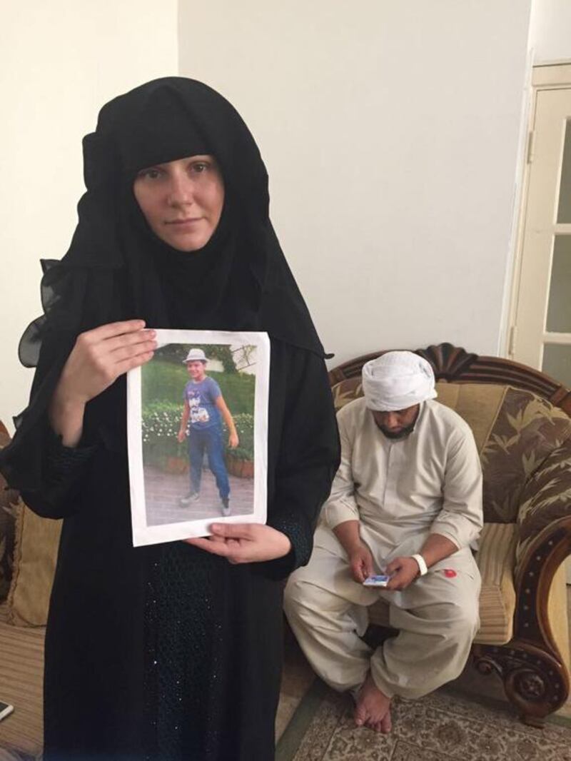 Tatiana Kruzina holds a picture of her son Athan. Behind is the father Majid Janjua. Haneen Dajani / The National