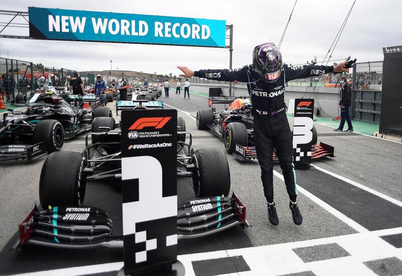 Lewis Hamilton celebrates after sealing victory in the Portuguese Grand Prix at the Algarve International Circuit on Sunday, October 25 - which took him to 92 race wins and a Formula One record. Reuters