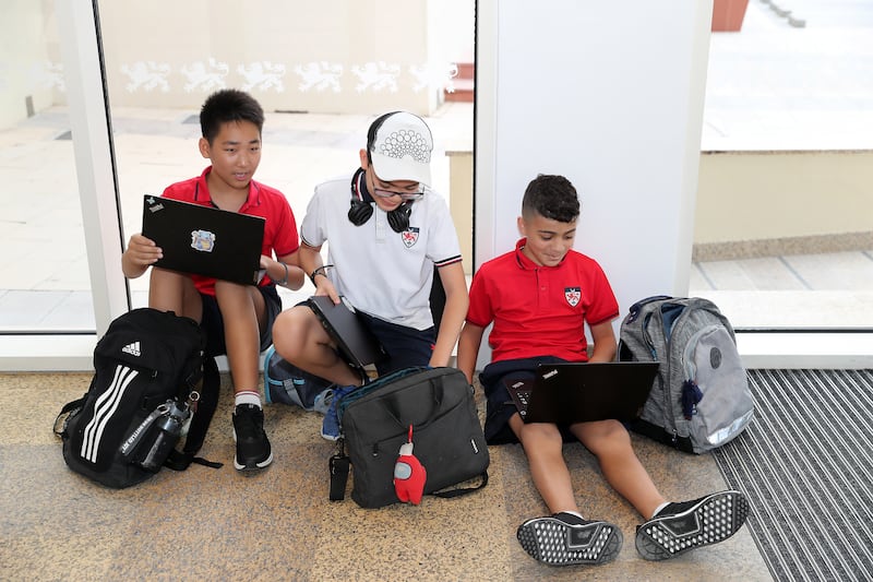 Pupils were keen to log on to their school laptops after the summer break. Pawan Singh / The National