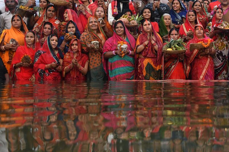 Indian devotees take part in a ritual worshipping of the sun god during the Chhath Festival on the banks of the holy river Ganges in Varanasi. AFP