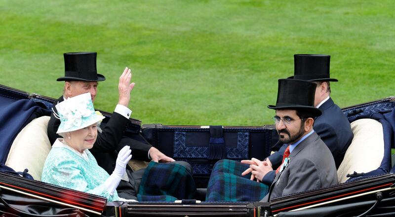 Britain's Queen Elizabeth II (2nd L) and her husband The Duke of Edinburgh (L) sit opposite Mohammed bin Rashid Al Maktoum (2nd R) as they arrive for the days' racing during Ladies Day, the third day of Royal Ascot, in Berkshire, west of London, on June 18, 2009. The five-day meeting is one of the highlights of the horse racing calendar. Horse racing has been held at the famous Berkshire course since 1711 and tradition is a hallmark of the meeting. Top hats and tails remain compulsory in parts of the course while a daily procession of horse-drawn carriages brings the Queen to the course. AFP PHOTO/Adrian Dennis (Photo by ADRIAN DENNIS / AFP)