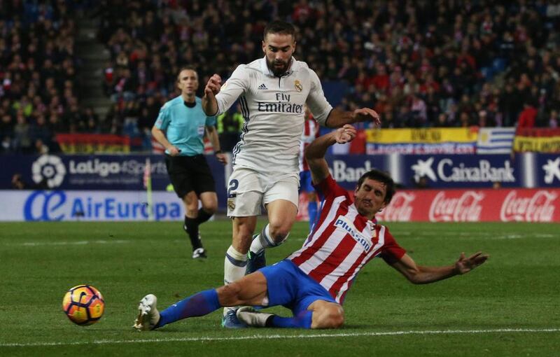 Real Madrid’s Daniel Carvajal in action with Atletico Madrid’s Stefan Savic. Sergio Perez / Reuters