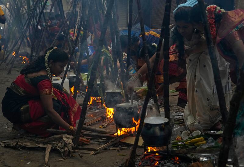 Tamil women cook special food to celebrate the harvest festival of Pongal in Dharavi, Mumbai. AP