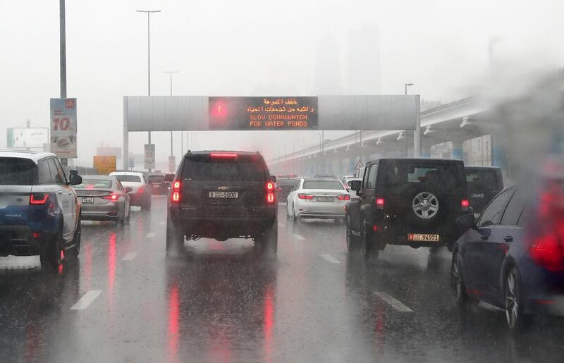 DUBAI, UNITED ARAB EMIRATES , Dec 11– 2019 :- RTA warning sign for the motorist during the morning rain on Sheikh Zayed road in Dubai. ( Pawan Singh / The National )  For News/Instagram/Online 