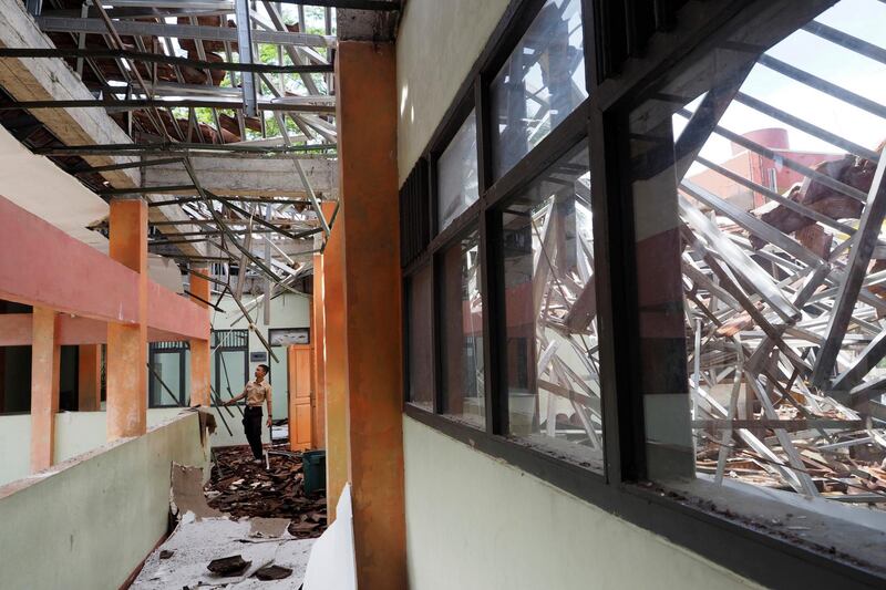A man inspects the damage at a school building following an earthquake in Tasikmalaya, West Java, Indonesia. Erwin Widiagiri / AP Photo