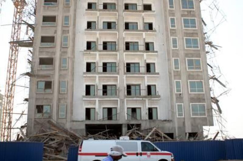 An external scaffolding collapsed on a residential building, sending several men falling to the ground on Sunday, Jan. 21, 2012, at Dubailand 3 near Dubai. Two men were dead on the spot and 10 - 15 men were taken away by an ambulance. The police rescuers still searched the building surroundings for additional survivors. (Silvia Razgova/The National)
