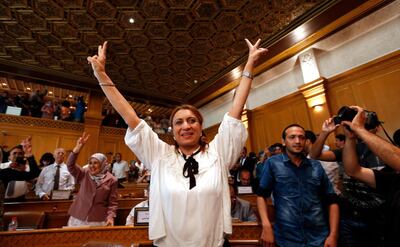 Souad Abderrahim, 54, flashes the V-sign after being elected as mayor of the Tunisian capital, Tunis, Tuesday, July 3, 2018. Souad Abderrahim of the Ennahdha party won the post in the second round of voting by the municipal council; the first time a woman holds the post. (AP Photo)