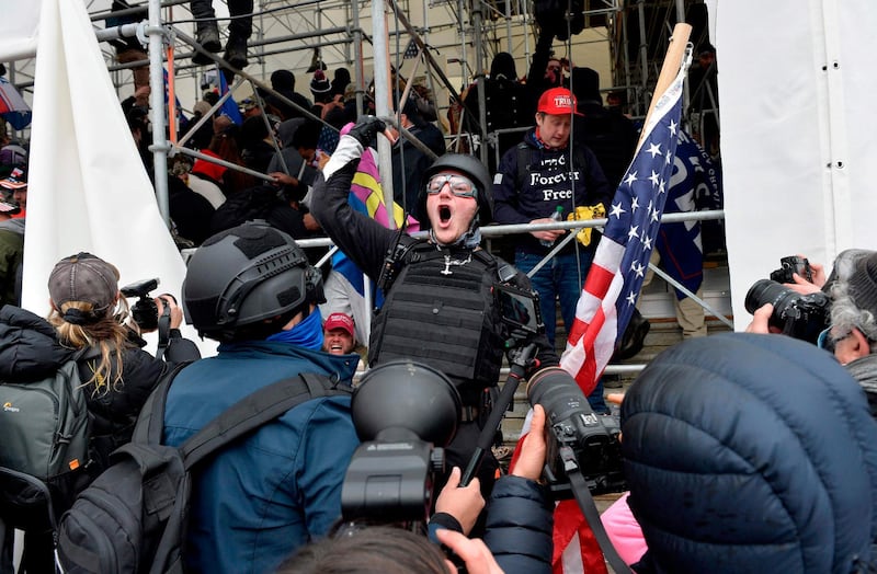 TOPSHOT - A man calls on people to raid the building as Trump supporters clash with police and security forces as they try to storm the US Capitol in Washington D.C on January 6, 2021.   Demonstrators breeched security and entered the Capitol as Congress debated the a 2020 presidential election Electoral Vote Certification. / AFP / Joseph Prezioso

