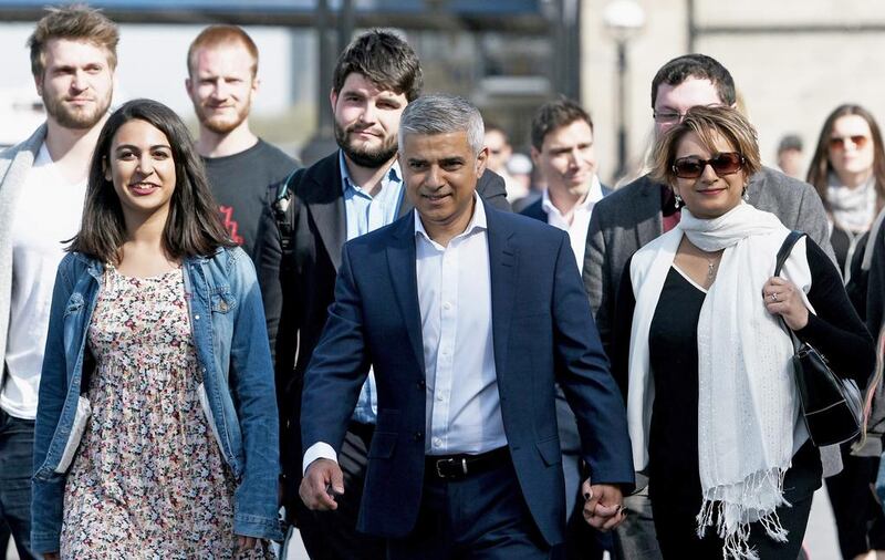 Sadiq Khan, the first Muslim mayor of London, arrives at City Hall on Friday, accompanied by his wife, Saadiya, family and aides. Mary Turner / Getty Images