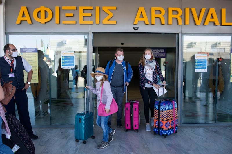 Tourists, arrive at Nikos Kazatzakis International Airport in Heraklion, Crete island, Greece, on Wednesday, July 1, 2020. The passengers most of them from Germany who came from Hamburg, with the first international flight to arrive in the island. Regional airports across Greece, including their tourist destination islands, began accepting direct international flights again on Wednesday, for the first time since flights were banned as part of the country's lockdown to prevent the spread of the coronavirus. (AP Photo/ Harry Nakos )