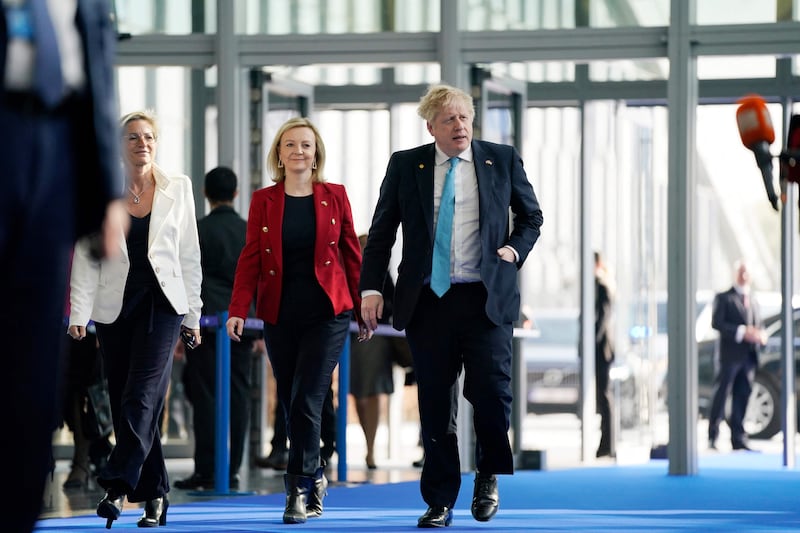 Boris Johnson and Liz Truss arrive for an extraordinary summit at Nato Headquarters in Brussels, in March this year. AFP