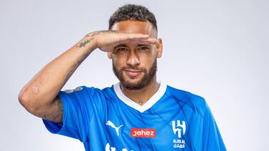 In this handout picture released by the Saudi Al-Hilal football club on August 15, 2023, Brazilian forward Neymar poses for a picture in the team's uniform in Riyadh.  Brazil forward Neymar has signed for Saudi Arabia's Al-Hilal from Paris Saint-Germain, the clubs announced today, joining Cristiano Ronaldo and Karim Benzema as the latest big name lured to the oil-rich Gulf state.  (Photo by Saudi Pro League  /  AFP)