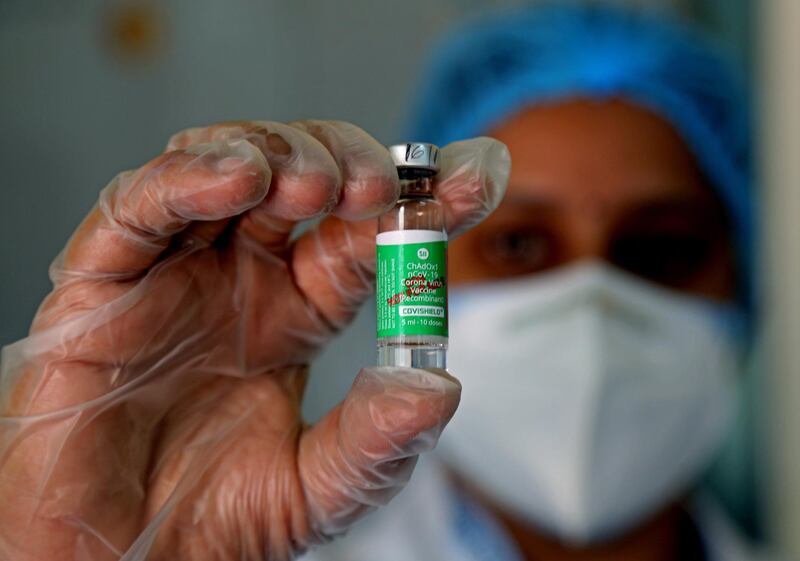 An Indian health worker holds up the Covishield Covid-19 vaccine, developed by Oxford University and Astra-Zeneca and manufactured by the Serum Institute of India, at the Government General Hospital in Jayanagar, Bangalore.  EPA