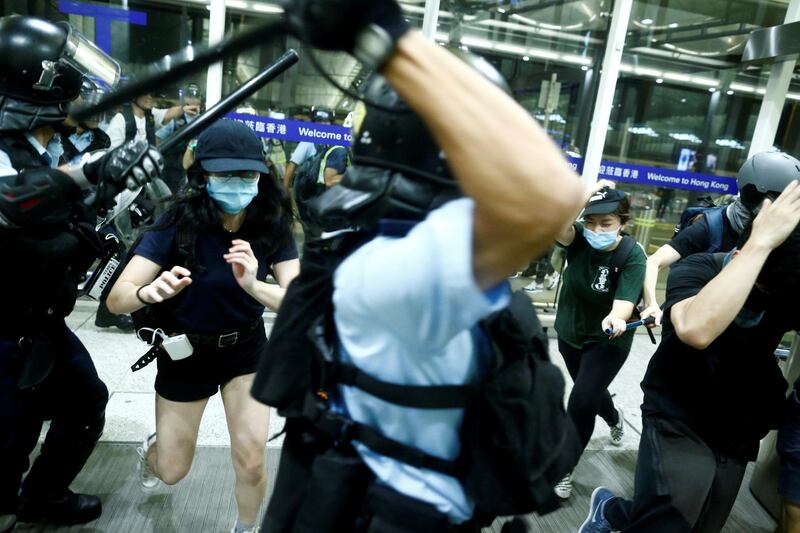 Police clash with anti-government protesters at the airport in Hong Kong. Reuters