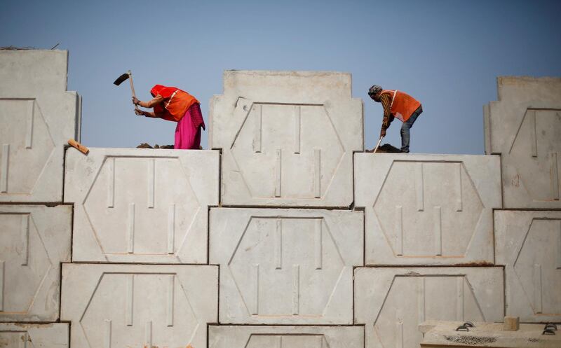 FILE PHOTO: Labourers work at the construction site of a flyover in New Delhi, India, February 1, 2018. REUTERS/Adnan Abidi/File Photo GLOBAL BUSINESS WEEK AHEAD