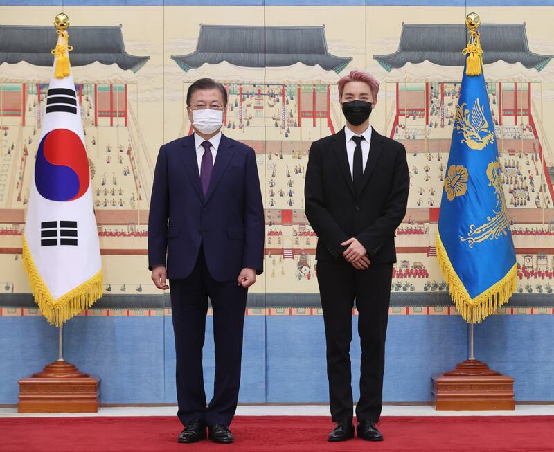 BTS member J-hope with the president. EPA
