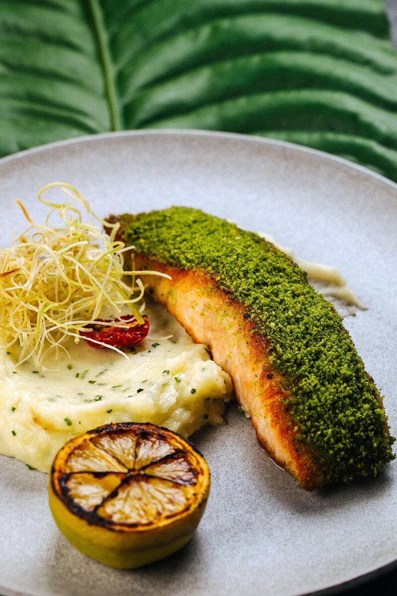 White Dubai's menu consists of dishes such as grilled salmon (pictured) risotto, Spanish Carabineros jumbo shrimp and tomahawk steak.