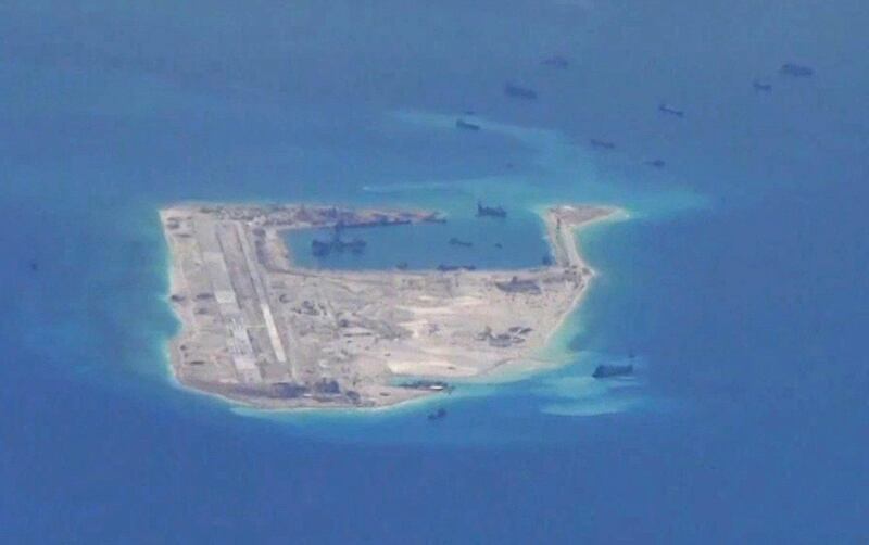 FILE PHOTO: Chinese dredging vessels are purportedly seen in the waters around Fiery Cross Reef in the disputed Spratly Islands in the South China Sea in this still image from video taken by a P-8A Poseidon surveillance aircraft provided by the United States Navy May 21, 2015. U.S. Navy/Handout via Reuters/File Photo ATTENTION EDITORS - THIS PICTURE WAS PROVIDED BY A THIRD PARTY. EDITORIAL USE ONLY