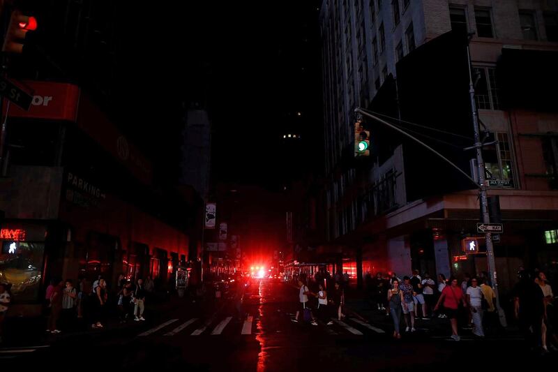 US citizens walk down a Manhattan street after a power outage hit the New York City borough. AFP