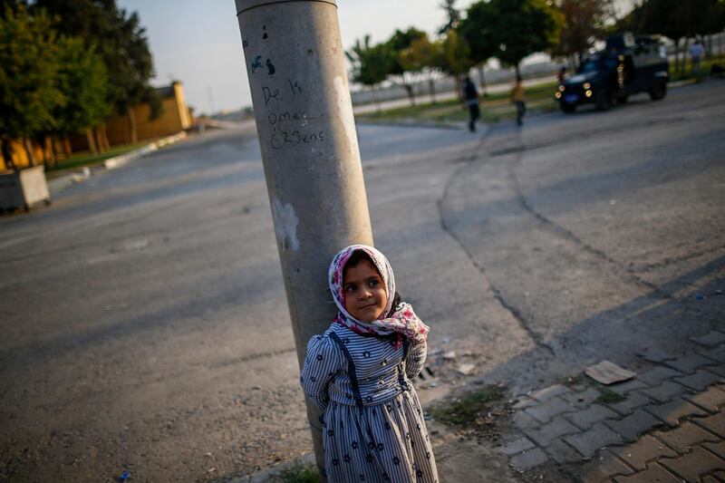 A child stands near the border crossing with Syria, in the border town of Akcakale, Sanliurfa province, southeastern Turkey. AP Photo
