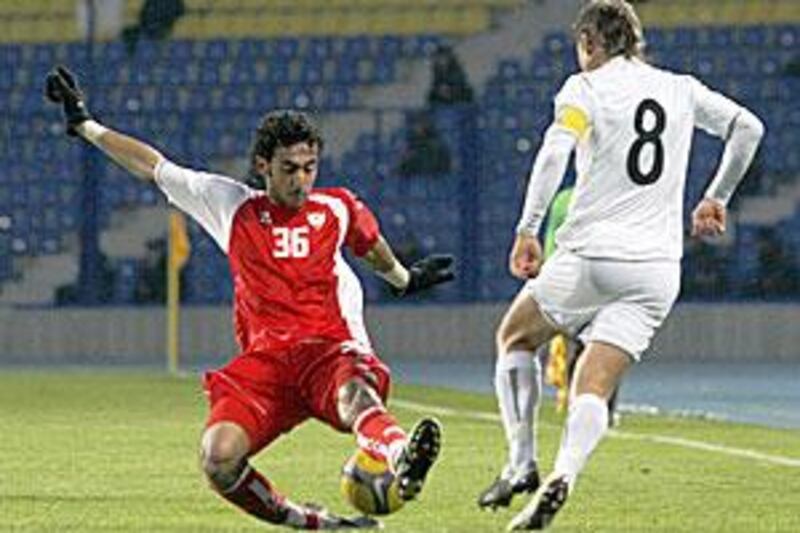 UAE's Yousef Al Hammadi is all over the ball before Server Djeparov of Uzbekistan can challenge him during their Asian Cup qualifying match in Tashkent.