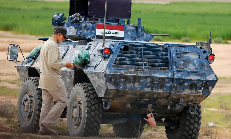 Iranian Revolutionary Guard Commander Qassem Soleimani walks near an armoured vehicle at the frontline during offensive operations against Islamic State militants in the town of Tal Ksaiba in Salahuddin province March 8, 2015. Picture taken March 8, 2015.   REUTERS/Stringer (IRAQ - Tags: CIVIL UNREST CONFLICT POLITICS)