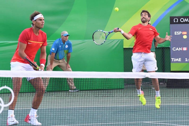 Spain’s Rafael Nadal and Spain’s Marc Lopez play against Canada’s Vasek Pospisil and Canada’s Daniel Nestor during their men’s doubles semi-final tennis match at the Olympic Tennis Centre of the Rio 2016 Olympic Games in Rio de Janeiro on August 11, 2016. Luis Acosta / AFP