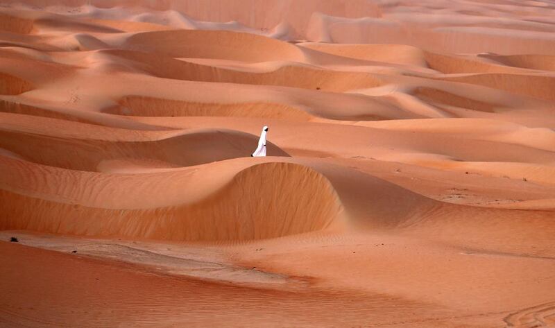 An Emirati man walks in the Liwa desert during the Liwa Moreeb Dune Festival.