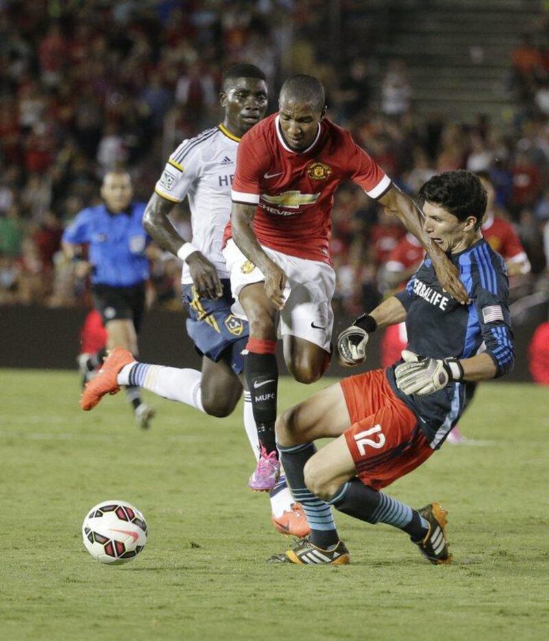 Manchester United's Ashley Young, centre, collides with LA Galaxy keeper Brian Rowe during their international friendly on Wednesday night at the Rose Bowl in Pasadena, California. AP Photo