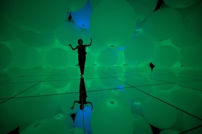 This photo taken on June 25, 2018 shows a member of teamLab posing at the two-year-long exhibition of teamLab, at the teamLab planets in Tokyo. - Collective teamLab, known internationally for their innovative "digital art" that combines projections, sound and carefully designed spaces to create immersive experiences, launched the teamLab Planets in Tokyo on June 27. (Photo by Martin BUREAU / AFP) / RESTRICTED TO EDITORIAL USE - MANDATORY MENTION OF THE ARTIST UPON PUBLICATION - TO ILLUSTRATE THE EVENT AS SPECIFIED IN THE CAPTION