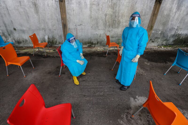 Health workers take a break from administering Covid-19 swab tests in Colombo, Sri Lanka. The country reported its first case of heavily mutated coronavirus Omicron variant of concern on December 3 in a citizen returning from South Africa. EPA