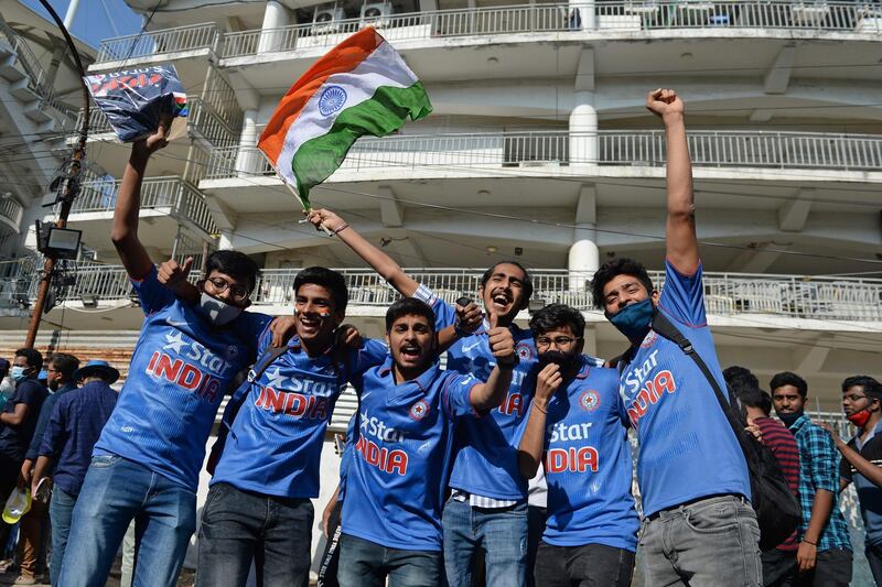 Fans holding the India flag cheer before the second Test between India and England outside the M.A. Chidambaram Cricket Stadium in Chennai. AFP
