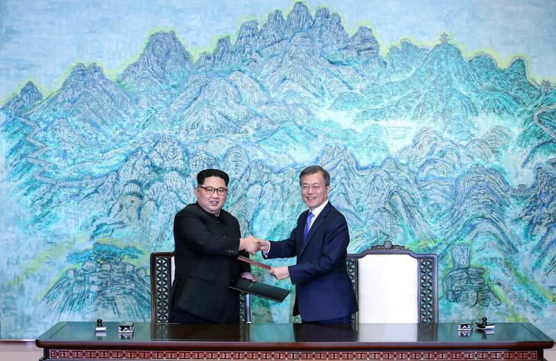 North Korean leader Kim Jong Un, left, and South Korean President Moon Jae-in shake hands after signing on a joint statement at the border village of Panmunjom in the Demilitarized Zone, South Korea, Friday, April 27, 2018. (Korea Summit Press Pool via AP)